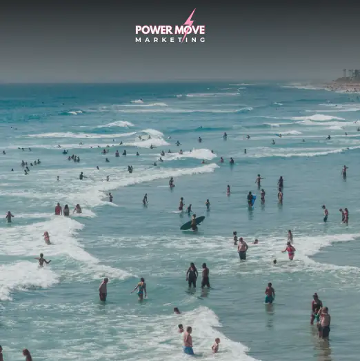 view of surfers all at the beach by and in the ocean